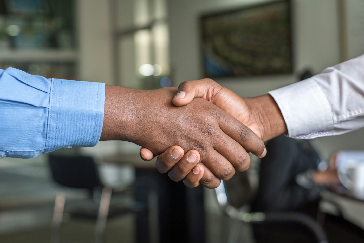 Two people shaking hands after a meeting