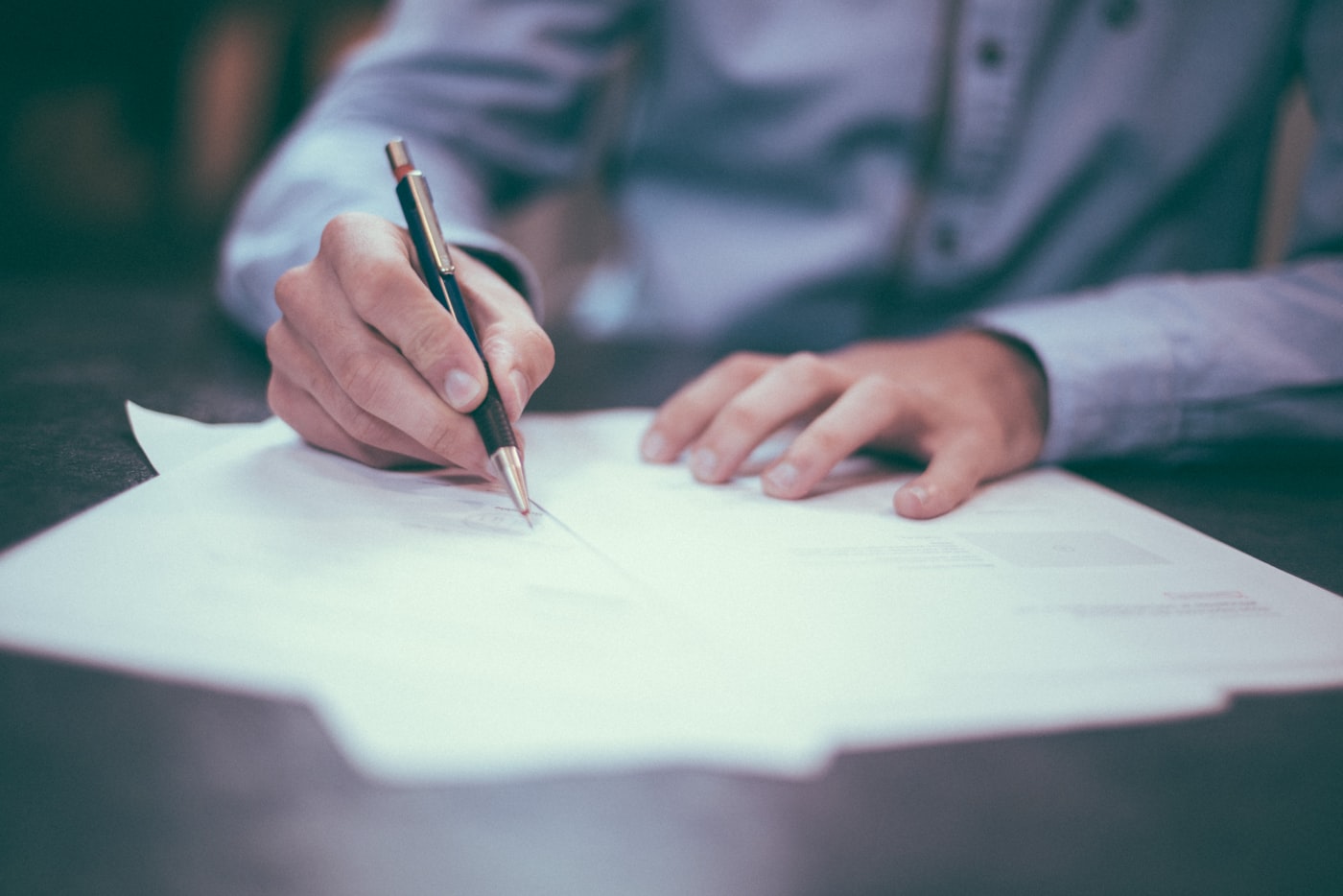 Hands reviewing a document with a pen